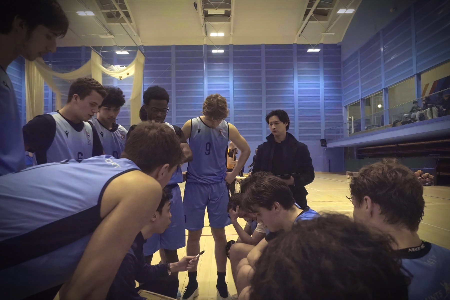 Alex coaching the university basketball team